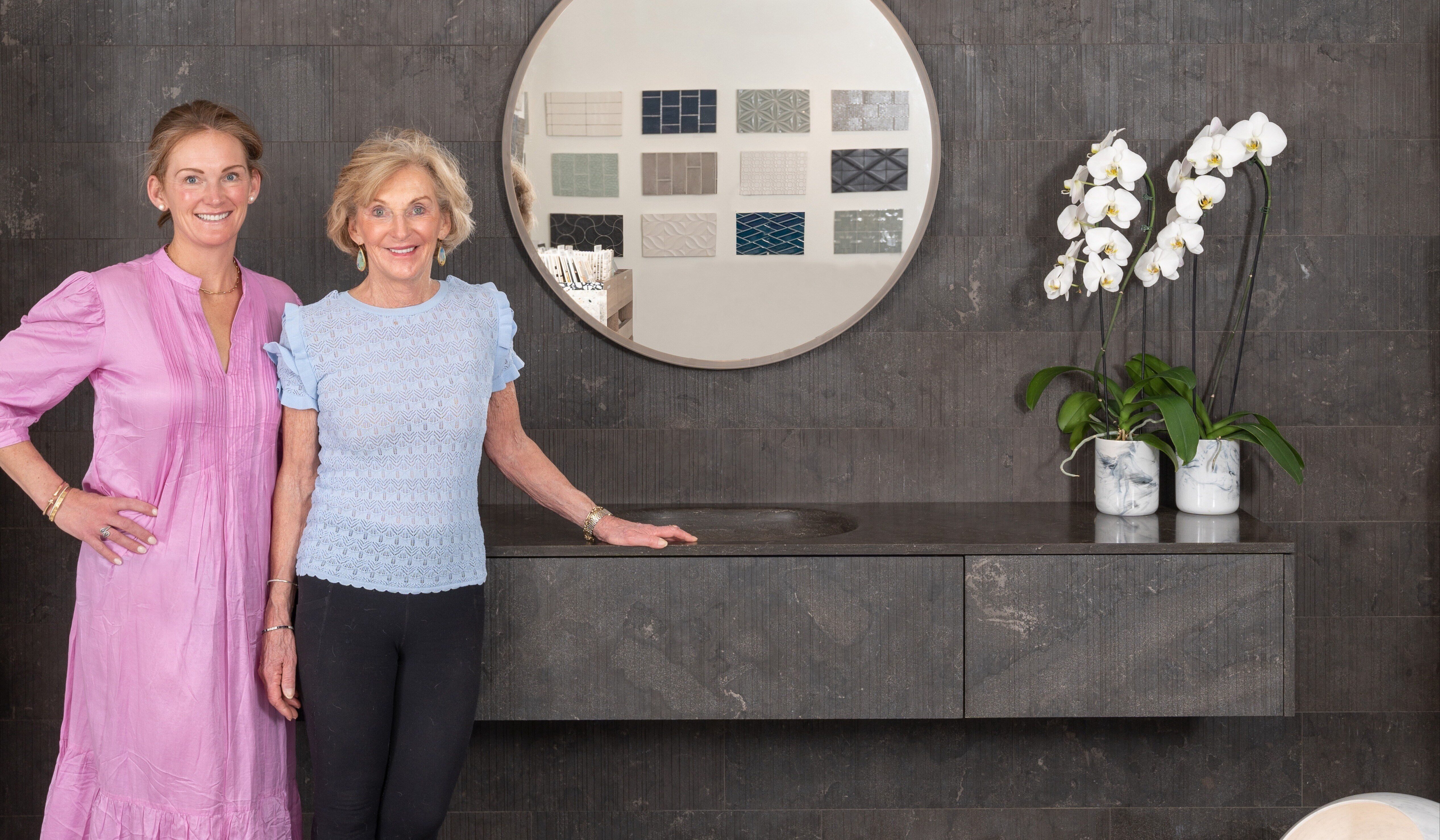 Kirsten Schmit, President, and Margot Hampleman, Founder and CEO, in front of a black Salvatori stone vignette in the Basalt Showroom